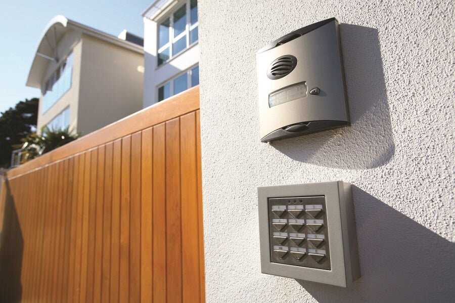 An exterior of a home featuring a home alarm and wall panel.