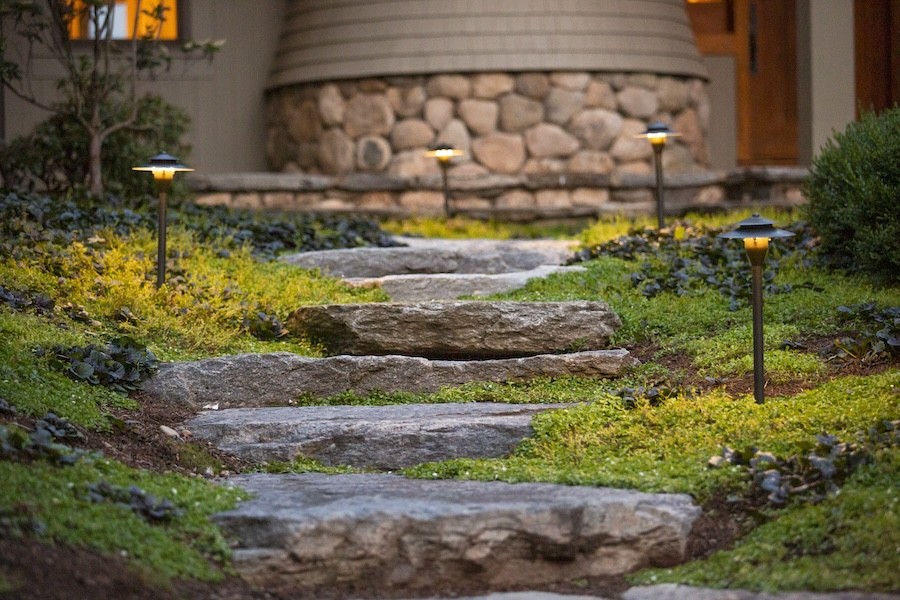 Pathlights from Coastal Source illuminating a stone walkway.