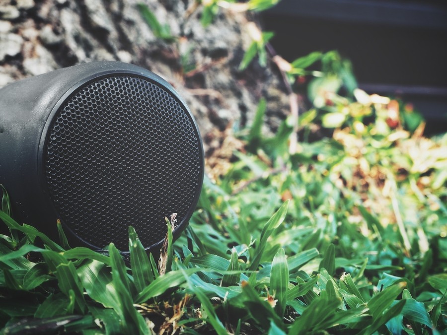  Image is of an outdoor speaker on a lawn. 