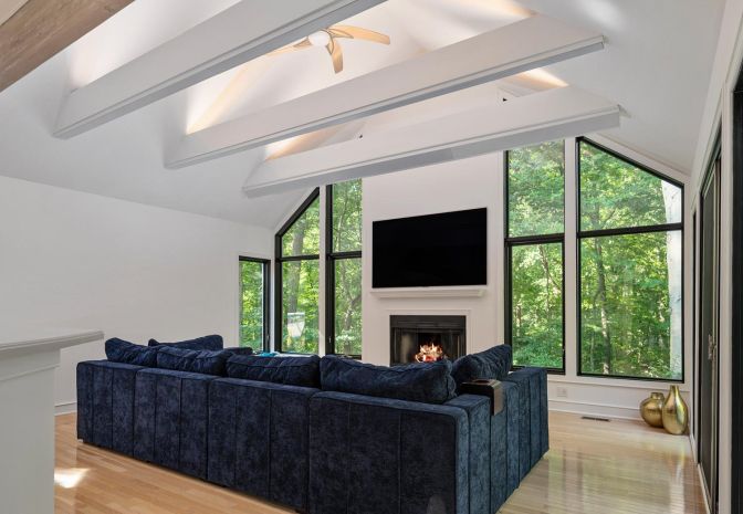 Living Room with white walls and a blue couch